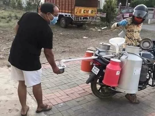Coronavirus: Milkman in India gets creative with 'invention' to maintain social distance
