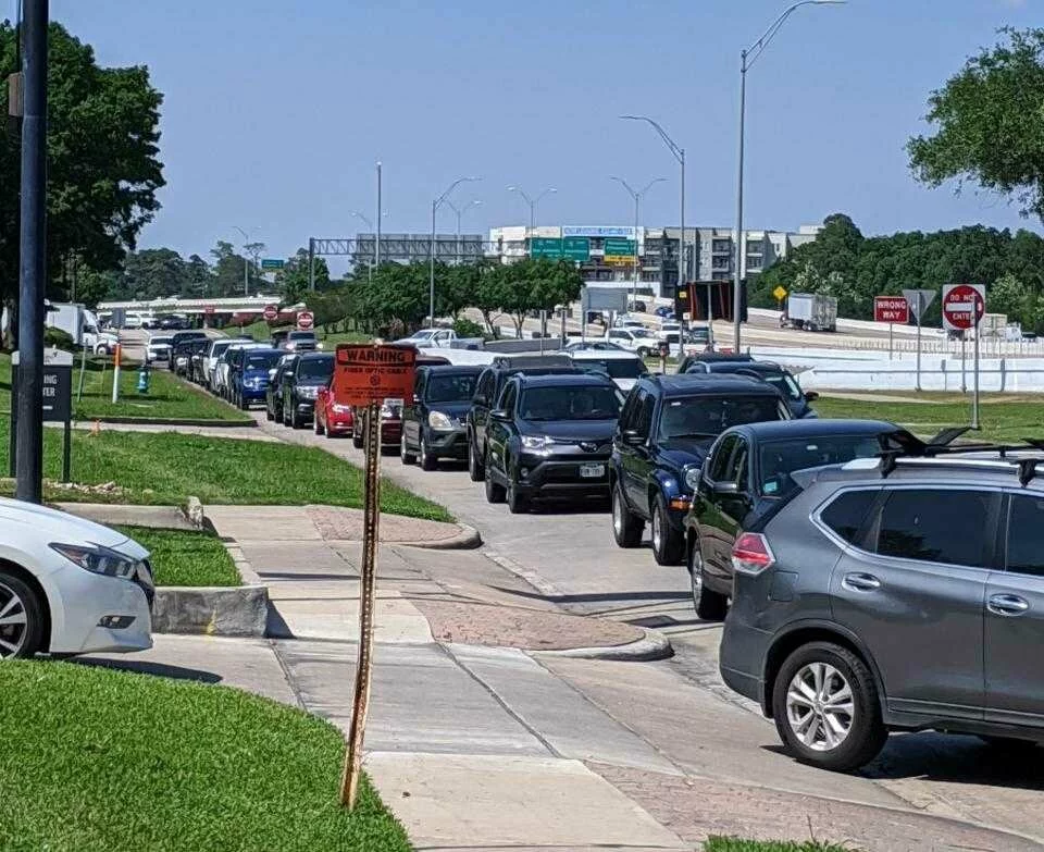  Cars were lined up for more than a mile Tuesday afternoon waiting for the Houston ISD food distribution center at Revere Middle School. 